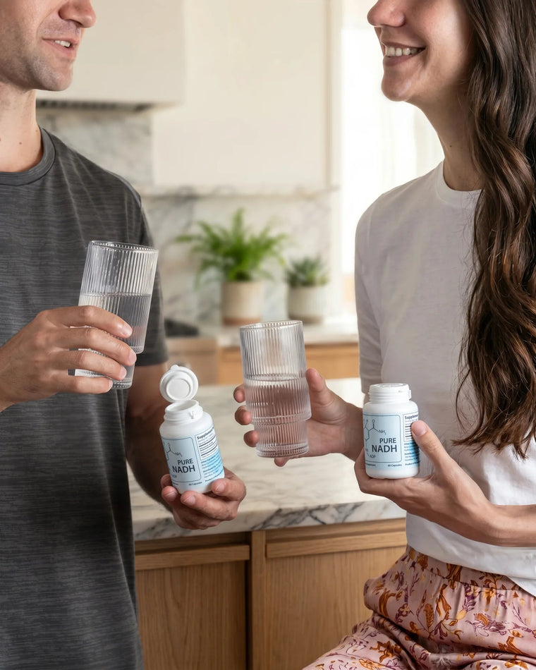 Couple starting the morning with PureNADH and glasses of water in the kitchen