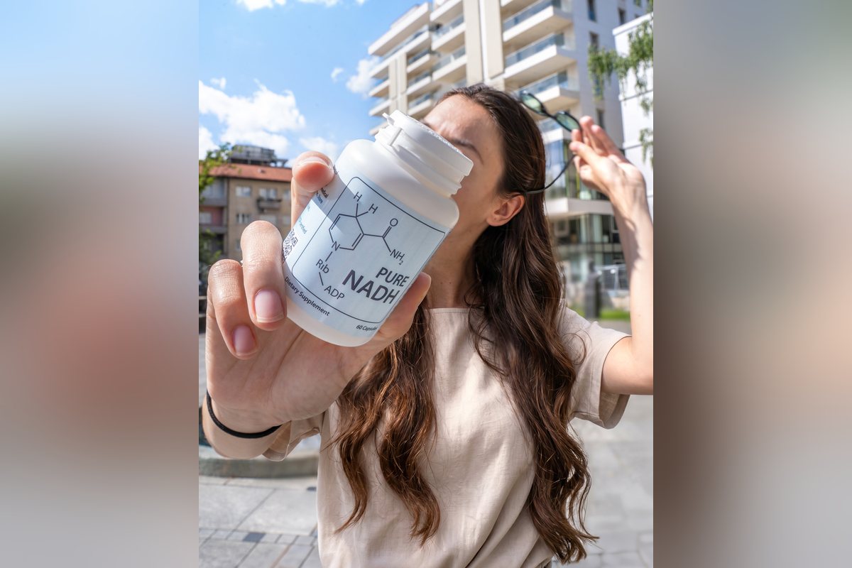 Customer holding PureNADH bottle outdoors in the sun