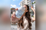 Customer holding PureNADH bottle outdoors in the sun